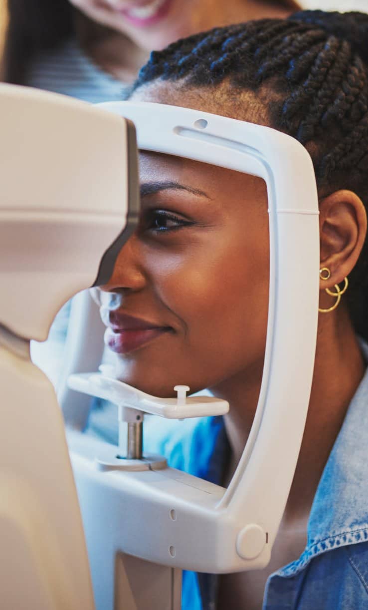 A woman having her left eye examined by an ophthalmologist for eye health and vision clarity