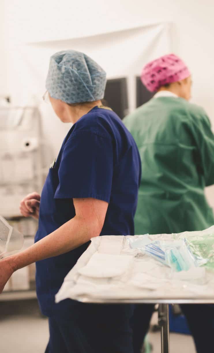 An ophthalmology surgeon and nurse preparing for eye surgery